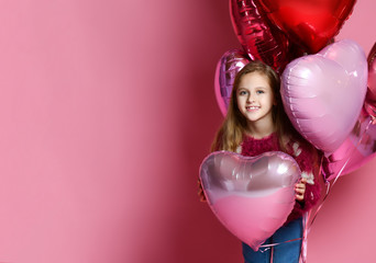 Happy Little girl holding a heart-shaped ballon