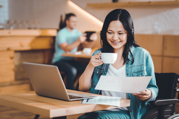 Pretty lady reading a month report