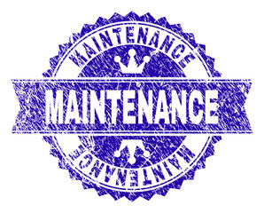 Obraz premium MAINTENANCE rosette seal imitation with distress texture. Designed with round rosette, ribbon and small crowns. Blue vector rubber print of MAINTENANCE tag with dirty texture.