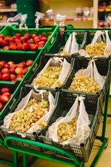 Variety of apples, oranges and grapes in boxes on city market