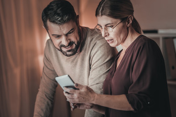 Reflective two colleagues receiving message