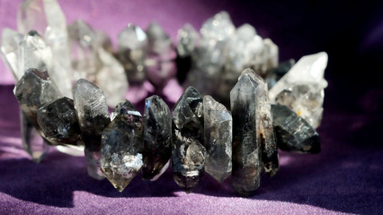 Black phantom quartz bracelet on violet background with space for write wording, lucky stone for...