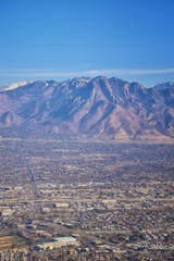 Aerial view of Wasatch Front Rocky Mountain landscapes on flight over Colorado and Utah during winter. Grand sweeping views near the Great Salt Lake, Utah Lake, Provo, Timpanogos, Lone and Twin Peaks 