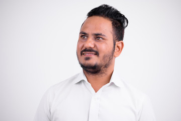 Fototapeta premium Face of happy bearded Indian businessman thinking