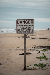 Danger Underwater Hazards Sign at the Beach