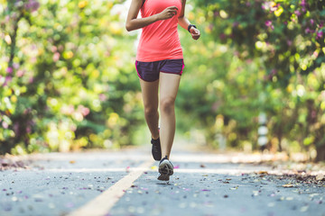 Asian woman runners she was running on the road in the morning.