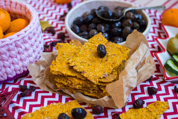 Black olives in bowl with crispy flat corn breads. Vegan and vegetarian healthy products