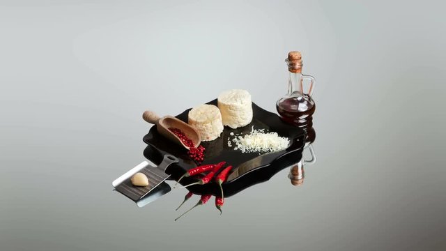 Art composition in the genre of still life with ricotta cheese, chilli peppers and a bottle of tincture