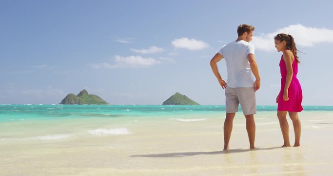 couple relaxing on paradise beach on travel vacation
