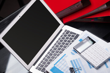 Office workplace with documents and stationery near red folders