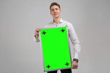 Portrait of young man with clean magnetic Board in his hands isolated on white background