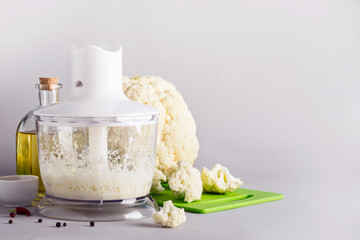 Fototapeta na wymiar Cooking cauliflower rice in a blender, copy space