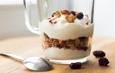 yogurt and muesli (crunchy, granola) in a glass cup, healthy nutrition