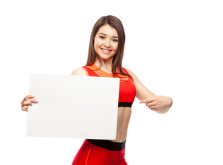 Beautiful athletic woman holding a poster and showing it.