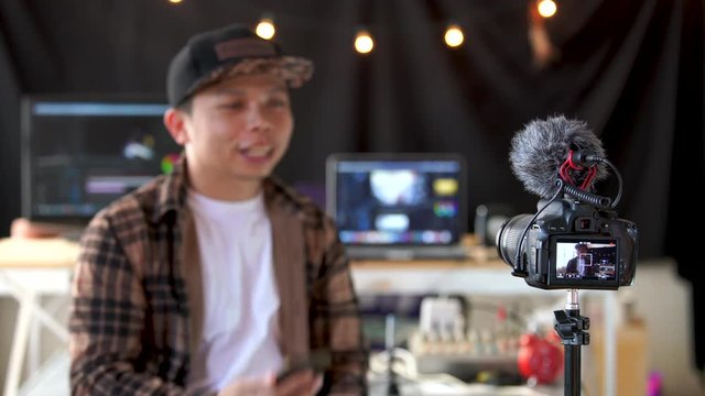 Asian male vlogger contents creator talking and looking in camera recording for blog