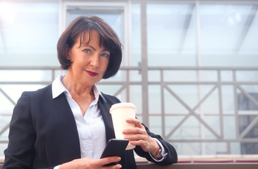 Businesswoman standing in front of an office building