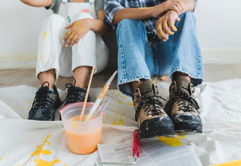 Couple taking a break from painting the walls