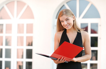 Business woman hold a folder at the office building