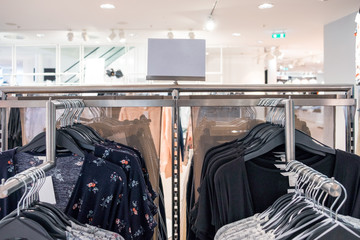 Women fashion clothes hanging on the rail with price tag