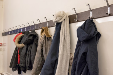 Winter jacket hanging on rack in deposit room