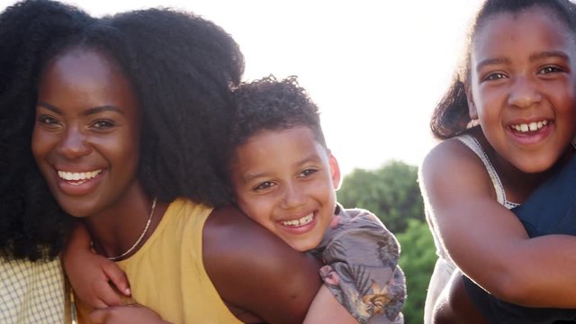 Multi generation black family, parents piggybacking kids