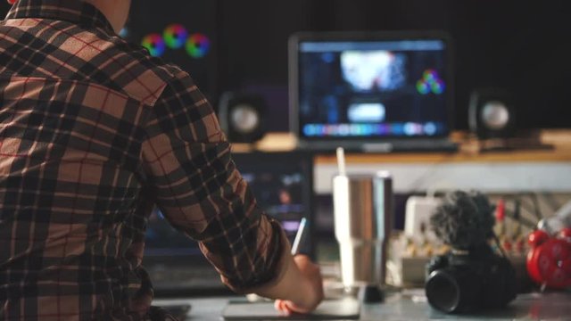 Freelancers editor man he working in house studio and Videography video content cut use laptop and monitor preview an this is lifestyle of creator