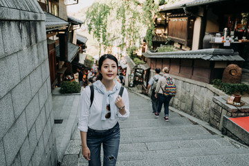 girl smiling walking up stairs in sannen zaka
