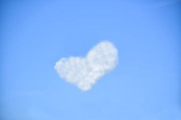 Naklejka na ściany i meble white clouds in the shape of heart on a blue sky