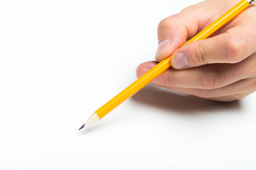 Men's hand holding wooden pencil on isolated backgroung, close up