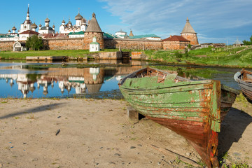 Old fishing boats on the shore against the background of the Transfiguration of the Solovetsky Monastery. Solovki, Russia © Konstantin
