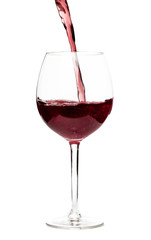 Beautiful splash of red wine in a glass on white background.