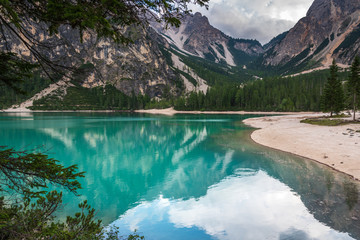 Dolomites. Braies lake and boats. Emerald colors on the water.