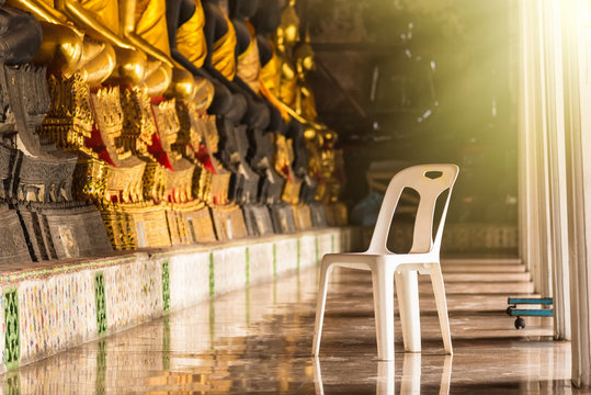 White plastic chair in Wat Suthat Devaravaram temple royal temple at the Giant Swing in Bangkok landmark of Bangkok, Thailand