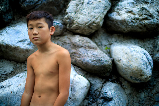 A boy whose upper body is naked.