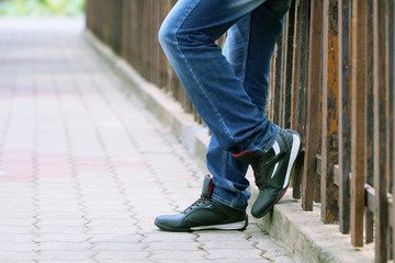 Portrait of young man posing to camera wearing the sports shoes