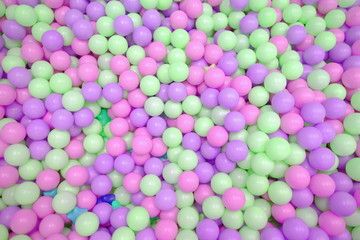 Kids ball pit or ball pool with many colorful balls as background