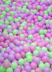 Kids ball pit or ball pool with many colorful balls as background