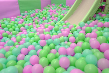 Kids ball pit or ball pool with many colorful balls as background