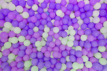 Kids ball pit or ball pool with many colorful balls as background