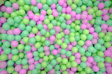 Kids ball pit or ball pool with many colorful balls as background