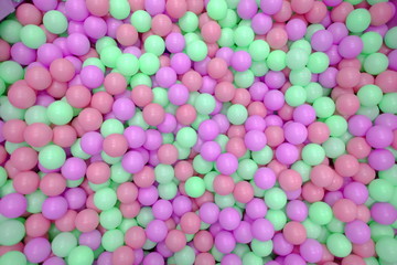 Kids ball pit or ball pool with many colorful balls as background