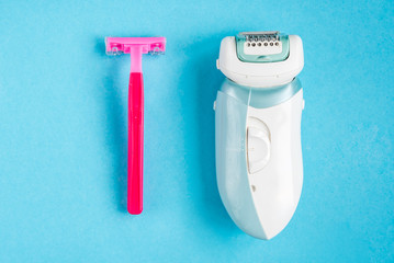 Razor or epilator on blue background.