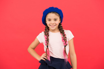 Teenage fashion. French fashion attribute. Child small girl happy smiling baby. Kid little cute fashion girl posing with long braids and hat red background. Fashion girl. Fashionable beret accessory
