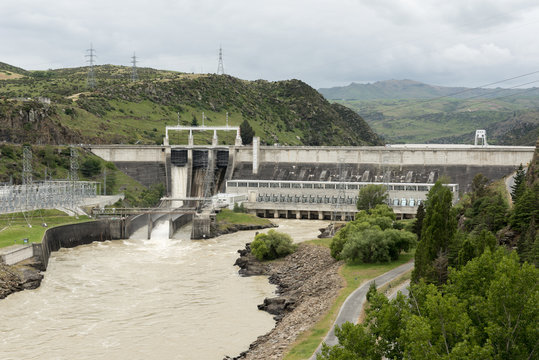 The Roxburgh hydroelectric power dam spilling excess water from one of its three spillways. Clutha River, Otago, New Zealand.