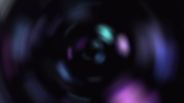 Abstract animation of a camera lens in iridescent flickering light as a background for text.