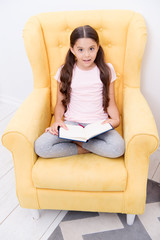Fototapeta premium small girl child with perfect hair. International childrens day. Happy little girl. Beauty and fashion. small kid fashion. Childhood happiness. I love my job. She has got the book she needs