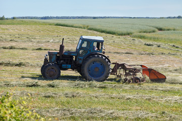 Fototapeta premium Small tractor on a field.
