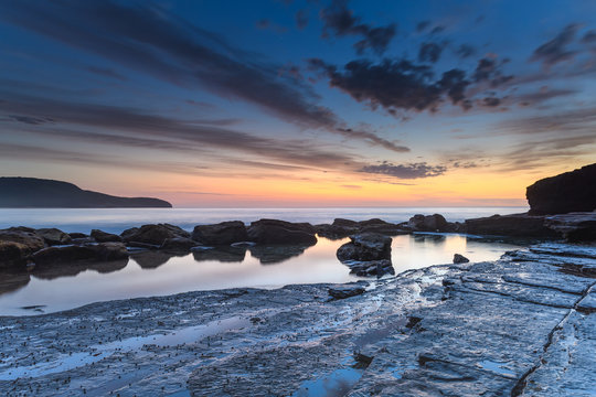 Dawn, Rocks, Reflections and Wispy Clouds Seascape