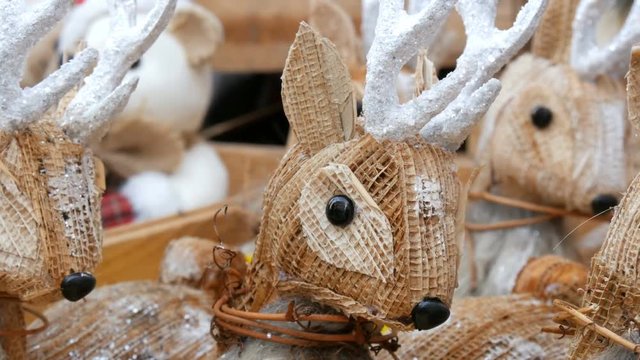 Beautiful Christmas decor in the form of straw figurines of deer on Christmas market