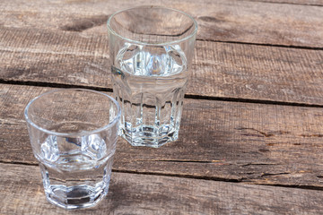 Glasses of water on a wooden table.